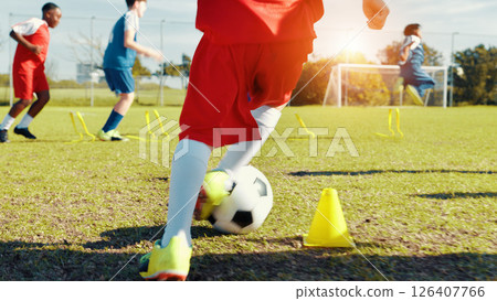 Soccer player, feet and children with ball, kick and athlete with energy for practice, cardio and legs. Playing, football and kids with sportswear for game, growth and development with fitness Soccer player, feet and children with ball, kick and athlete with energy for practice, cardio and legs. Playing, football and kids with sportswear for game, growth and development with fitness 126407766