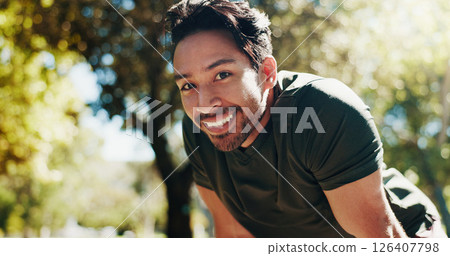 Tired, running and portrait of man in nature for cardio workout, exhausted and training break. Smile, health and fitness rest with person outdoor for fatigue, sports athlete and marathon practice 126407798