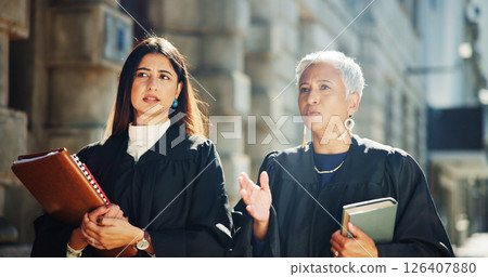 Women, judge and talking in city outdoor for courtroom discussion, legal team and justice procedure. People, lawyers and conversation of investigation, hearing process and information for jury recess 126407880