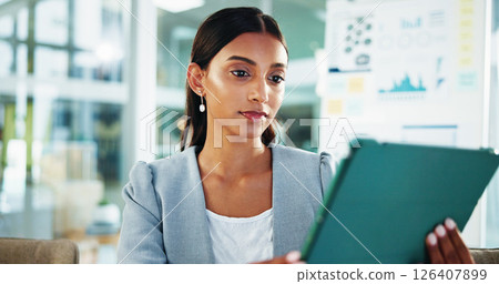 Reading, thinking and business woman with tablet for accounting, economy update or finance report in office. Scroll, online and financial advisor with portfolio advice, research graphs or investment 126407899