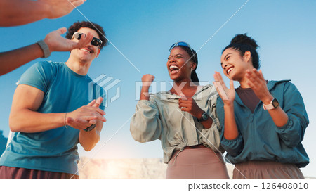 Runner, group and applause with celebration outdoor for marathon success, workout goals and achievement. Low angle, friends and teamwork support for endurance challenge, running victory and fitness 126408010