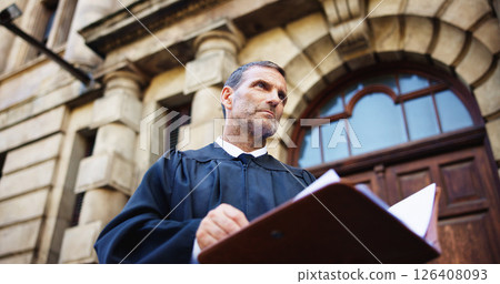 Thinking, judge and mature man with court, confidence and pride for career ambition and success. Person, low angle and attorney with lawyer, constitution and law firm for justice system knowledge 126408093