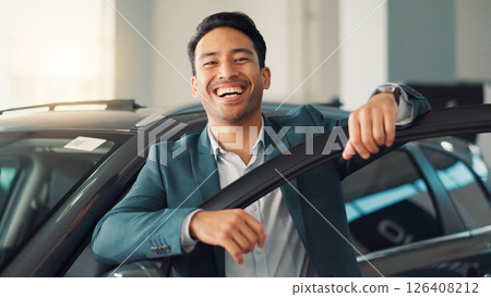 Happy man, face and salesman with confidence at car dealership for promotion, discount and offer. Seller, agent and proud broker in portrait for business and display vehicle at showroom in Mexico Happy man, face and salesman with confidence at car dealership for promotion, discount and offer. Seller, agent and proud broker in portrait for business and display vehicle at showroom in Mexico 126408212