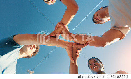 Fitness, below and group holding hands for solidarity, collaboration or support outdoor with blue sky. Friends, people and community together for motivation, exercise goal and happy team with synergy Fitness, below and group holding hands for solidarity, collaboration or support outdoor with blue sky. Friends, people and community together for motivation, exercise goal and happy team with synergy 126408214
