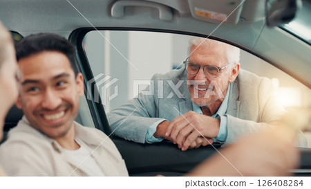 Drive, salesman and couple with laughing in car dealership, transport model and rental service. Showroom, people and mature seller with pitch for vehicle features, assistance and discussion by flare 126408284