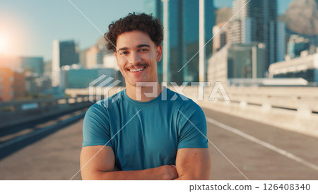 Arms crossed, exercise and portrait of man on bridge in city for cardio workout or marathon training. Fitness, smile and sports with happy athlete or runner outdoor in urban town for challenge 126408340