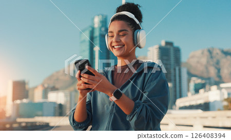 Happy woman, fitness and listening with phone in city for workout playlist, sound or music app. Active, female person or user with smile, mobile smartphone or headphones for audio streaming in town Happy woman, fitness and listening with phone in city for workout playlist, sound or music app. Active, female person or user with smile, mobile smartphone or headphones for audio streaming in town 126408394
