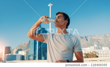 Man, fitness and drinking water in city for break, natural sustainability or refreshment. Active, male person or thirsty runner with mineral liquid, aqua or beverage for hydration, recovery or rest Man, fitness and drinking water in city for break, natural sustainability or refreshment. Active, male person or thirsty runner with mineral liquid, aqua or beverage for hydration, recovery or rest 126408395