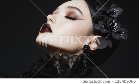 A gothic woman in black with dramatic makeup 126409360