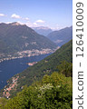 Aerial view of Como city and Lake Como, surrounded by hills and mountains Alps, with boats on the water and scenic urban landscape in northern Italy. 126410009