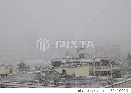 A snowy cityscape with a few buildings in the background A snowy cityscape with a few buildings in the background 126410064