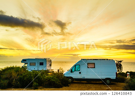Camper vehicles on beach at sunrise Camper vehicles on beach at sunrise 126410843