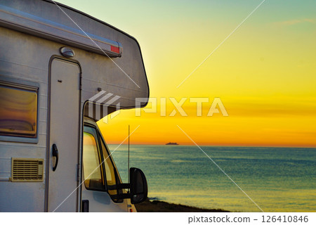 Camper vehicle on beach at sunrise Camper vehicle on beach at sunrise 126410846