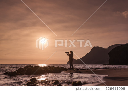 Woman with camera on Monsul beach, Spain Woman with camera on Monsul beach, Spain 126411006