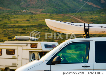Canoe on roof top of car van 126411012