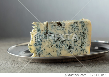 Gorgonzola cheese on a gray stone table. 126411046