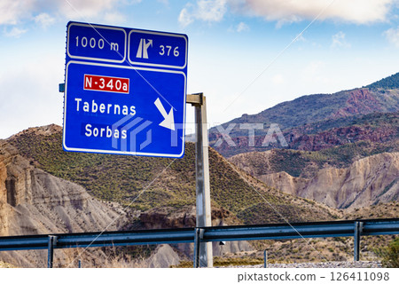 Tabernas desert landscape and road sign, Spain 126411098