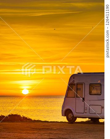 Camper vehicle on beach at sunrise 126411190