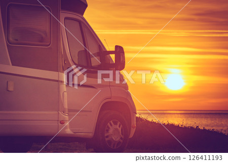 Camper vehicle on beach at sunrise Camper vehicle on beach at sunrise 126411193