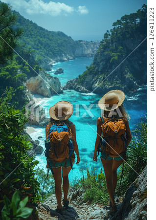 Couple hiking along a tropical cliff with ocean views, backpacks, sun hats, exploring nature, 126411223
