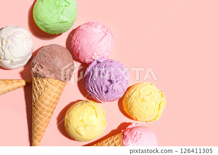 Ice cream scoops and waffle cones on pink background Ice cream scoops and waffle cones on pink background 126411305