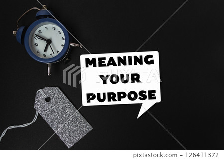 Blue alarm clock sits on a black background 126411372