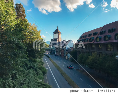 A street with a tall building in the background A street with a tall building in the background 126411374