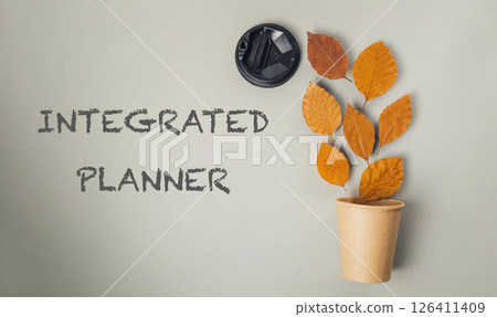 Leafy plant in a brown cup with the words Integrated Planner written below it 126411409