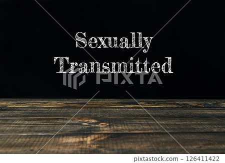 a wooden table with the words Sexually Transmitted a wooden table with the words Sexually Transmitted 126411422