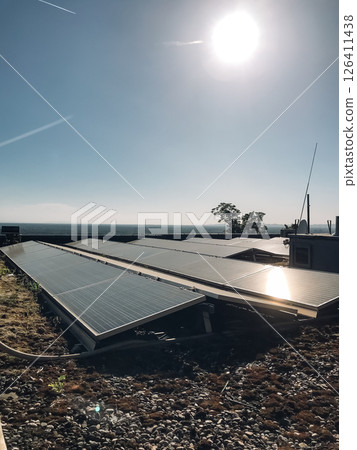 A solar panel array is installed on a roof 126411438
