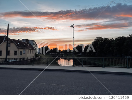 Street with a bridge and a house in the background 126411469