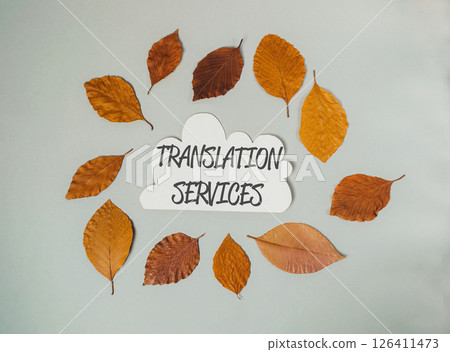 Translation services are displayed in a circle of leaves Translation services are displayed in a circle of leaves 126411473