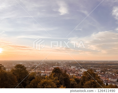 Beautiful sunset over a city with a few clouds in the sky Beautiful sunset over a city with a few clouds in the sky 126411490