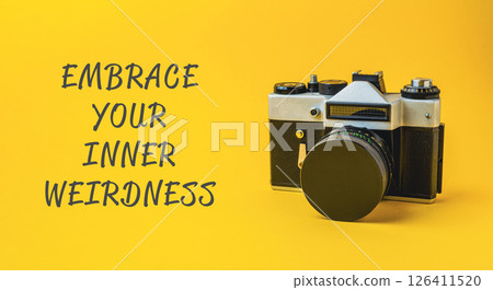 A camera with the words embrace your inner weirdness written below it 126411520