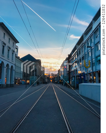 A city street with a train track running down the middle 126411832