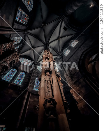 Tall pillar with a statue of a woman on top of it 126411839