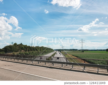 A highway with a bridge over it and a field in the background 126411849