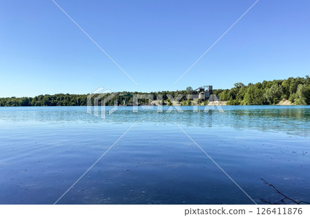 Calm lake with a blue sky in the background Calm lake with a blue sky in the background 126411876