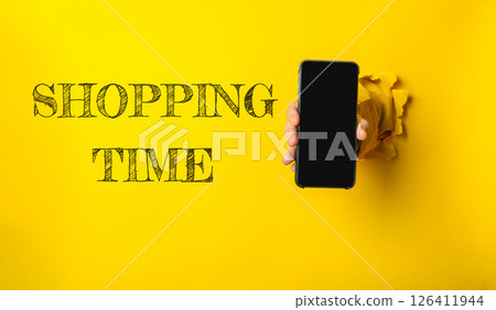 A person holding a phone with the words shopping time written on it 126411944