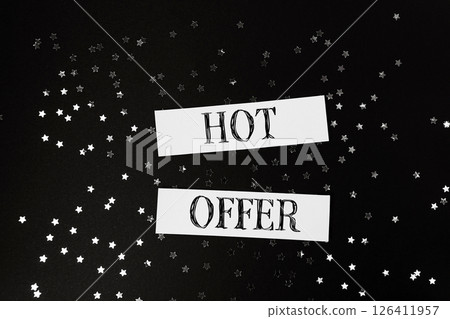 Hot offer is written on a black background with stars scattered around Hot offer is written on a black background with stars scattered around 126411957