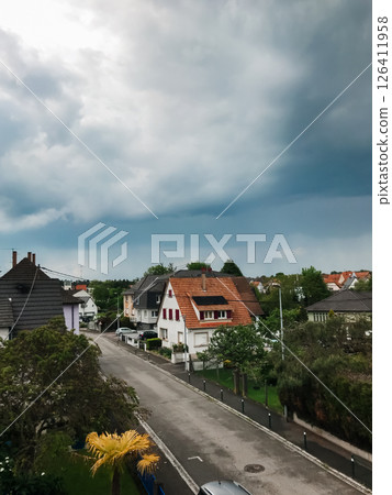 A street with houses and a cloudy sky A street with houses and a cloudy sky 126411958
