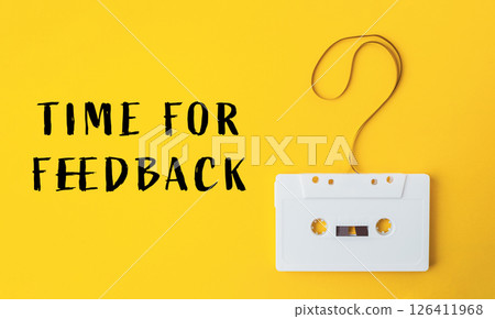 White cassette tape is hanging from a string with a question mark on it 126411968