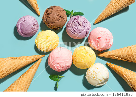 Ice cream scoops and waffle cones on blue background 126411983