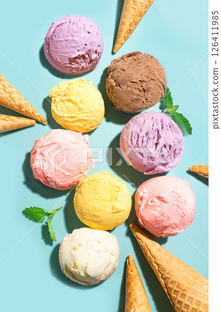 Ice cream scoops and waffle cones on blue background Ice cream scoops and waffle cones on blue background 126411985