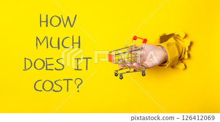 A hand holding a shopping cart A hand holding a shopping cart 126412069