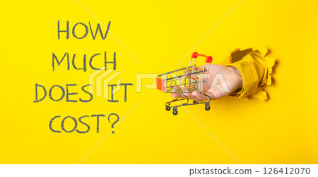 A hand holding a shopping cart A hand holding a shopping cart 126412070