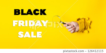 Hand holding a magnifying glass with the words Black Friday Sale written below Hand holding a magnifying glass with the words Black Friday Sale written below 126412115
