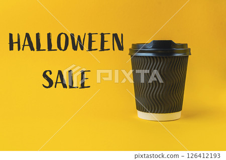 Coffee cup with a Halloween sale sign on it 126412193