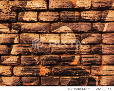 A brick wall with a star and a leaf on it 126412234