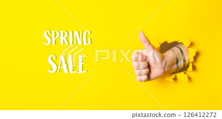 A hand giving a thumbs up with the words Spring Sale written underneath 126412272